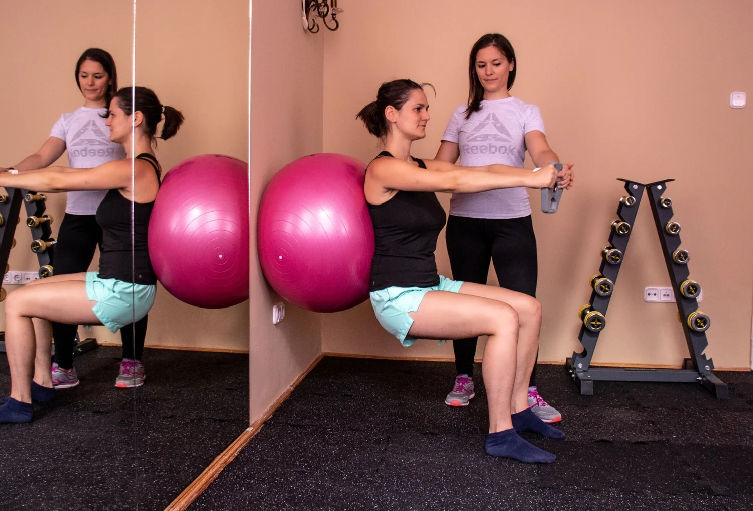 female personal trainer with client doing exercise